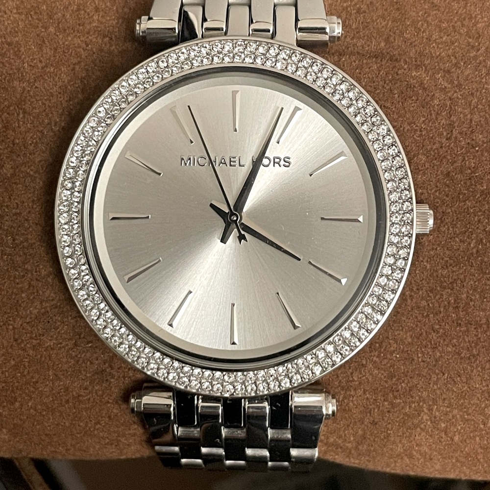 Brand new never used Micheal Kors watch. Silver, round.